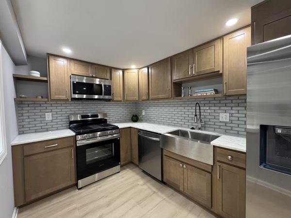 Farmhouse sink, gas range and subway-tile backsplash